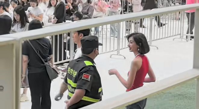 外传为黄恺杰新婚妻子的红衣女子和保安谈笑风生。